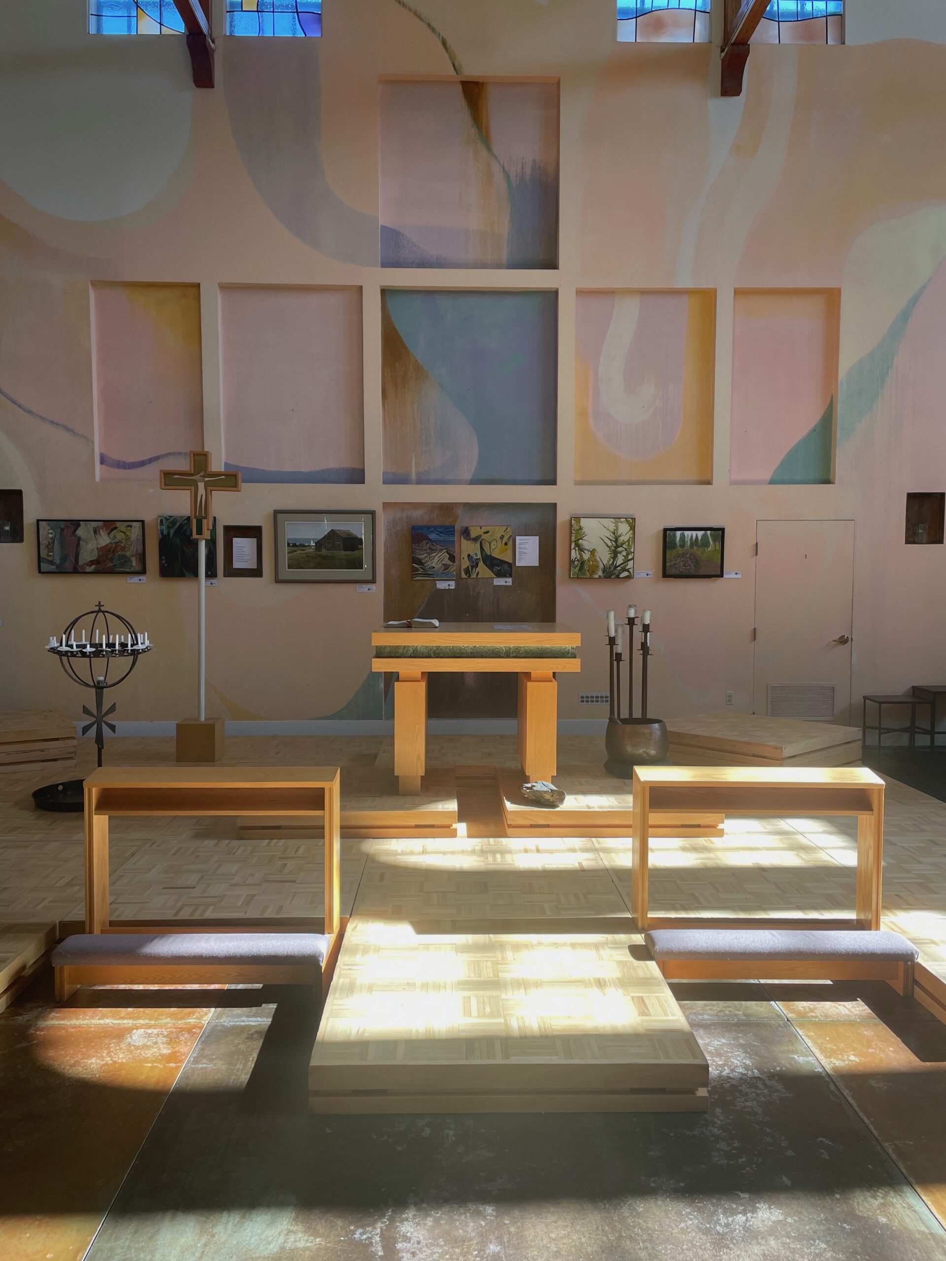 Photo of the Peace Sanctuary prepared for Sunday Worship, with sunlight and shadows playing across the chancel.