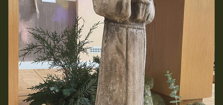 Photo of the Peace Altar prepared for honoring Saint Francis. A Saint Francis statue with statues of animals surrounding by plants.