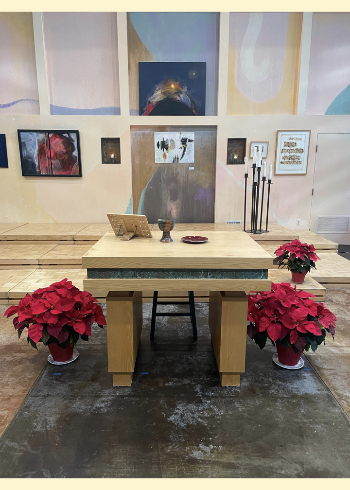 The Peace Altar prepared for Worship with the Chalice and poinsettia plants surrounding it.