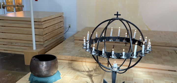 The Peace Sanctuary's Light Globe with the candles lit in front of the Singing Bowl and the Processional Cross.