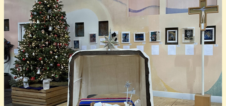 A photo of the Manger, Christmas Tree, and Processional Cross before Worship in the Peace Sanctuary on December 29th 2024.