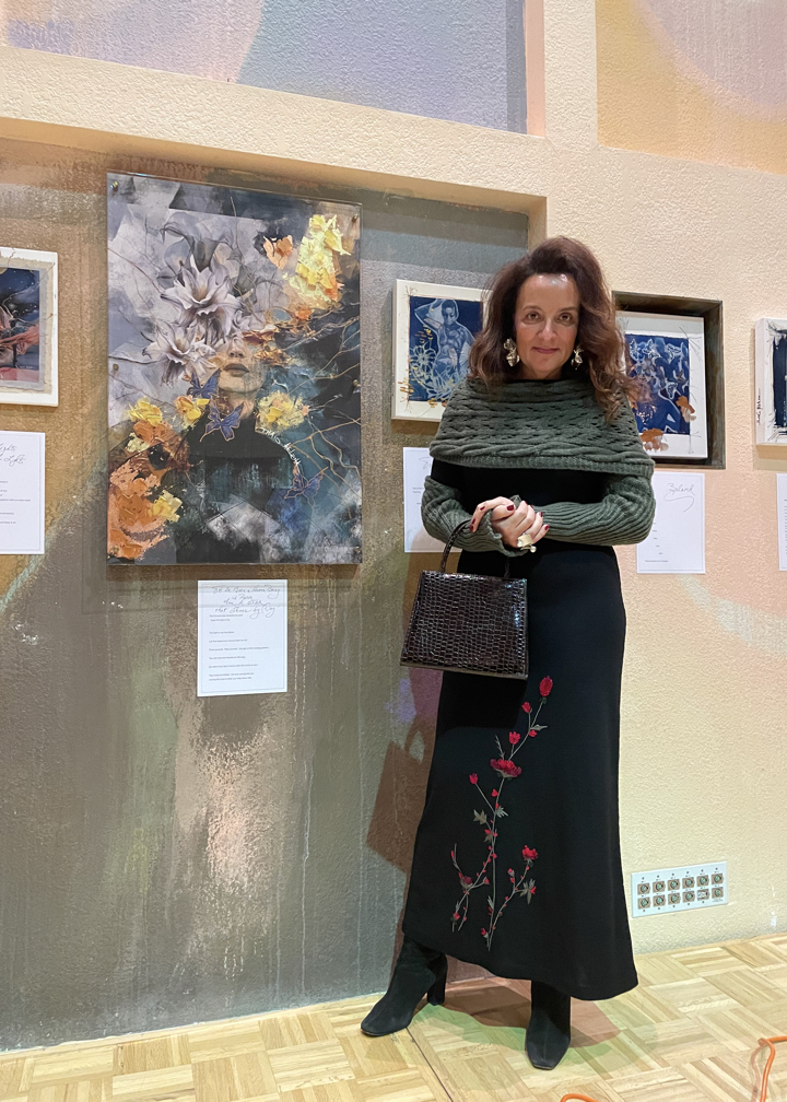 Artist Thais Ouzounian standing with her Advent Art Exhibit in the Peace Sanctuary.